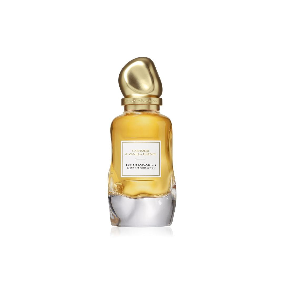 A bottle of Dior Sauvage & Vanilla Elixir perfume with a gold cap and a clear glass body showing the amber liquid inside, set against a plain white background.