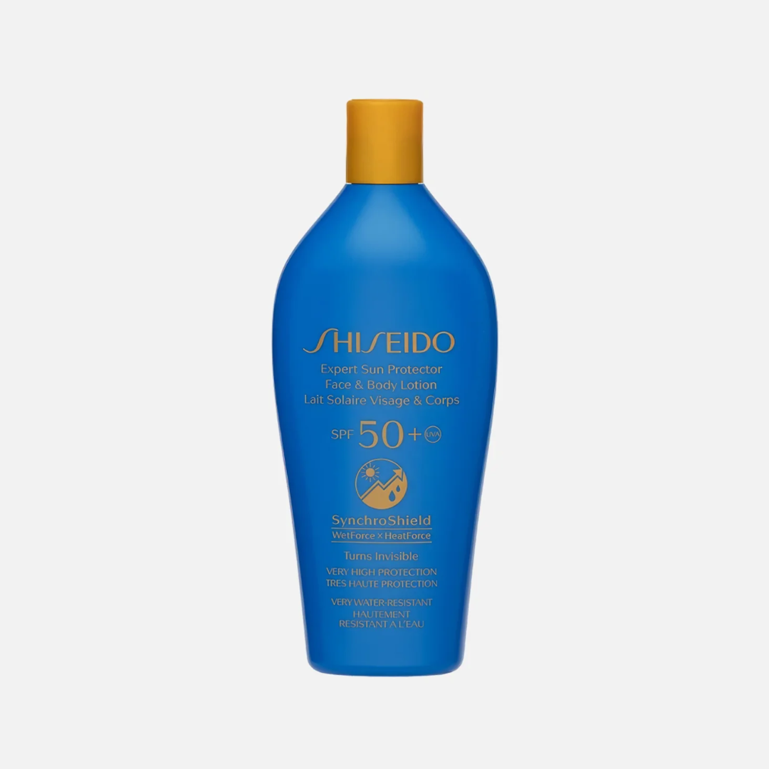Shiseido Expert Sun Protector Face, Body, and Hands Lotion in a blue bottle with a gold cap, shown on a light gray background.