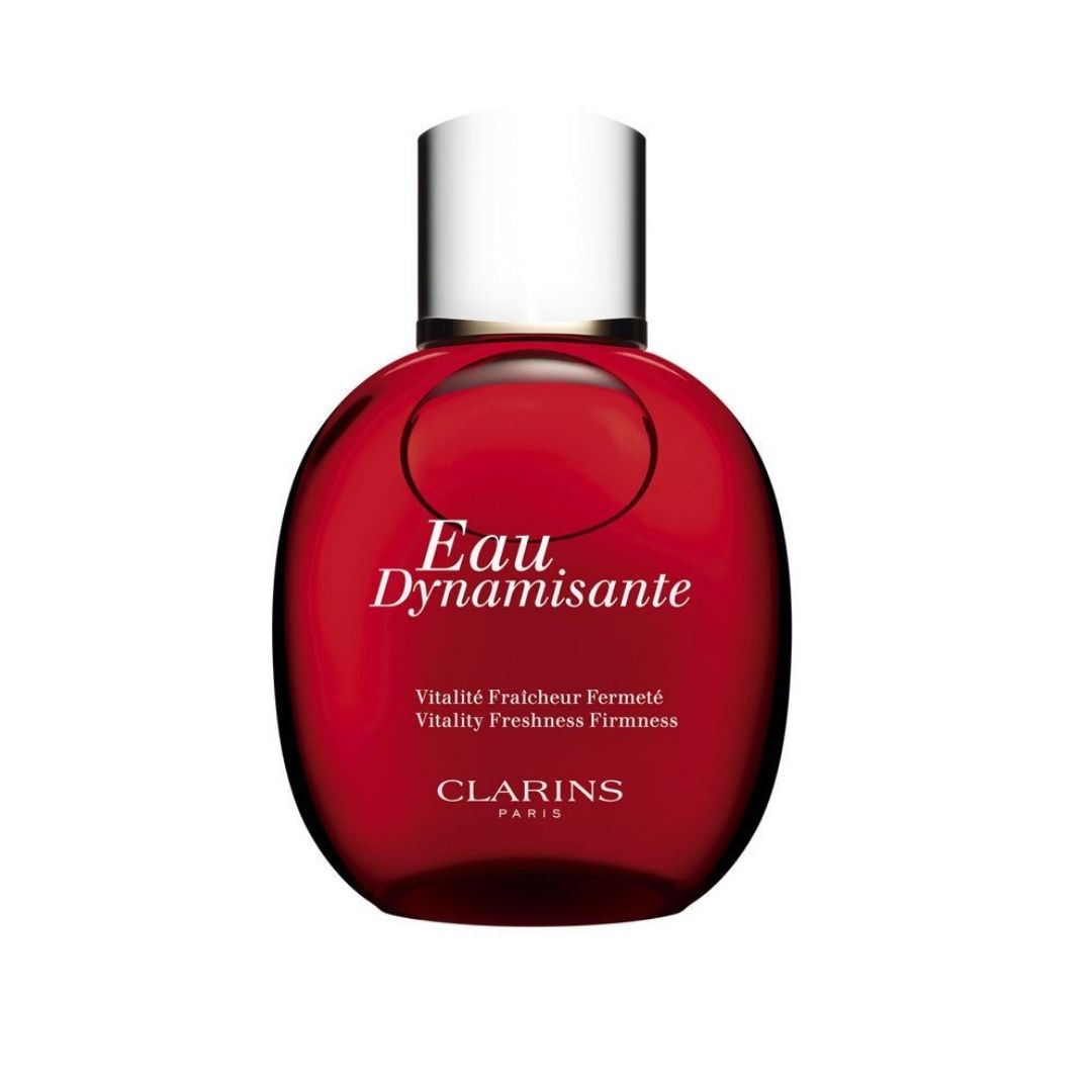 Clarins Eau Dynamisante cosmetic bottle in a deep red translucent glass with a silver metallic cap, shown on a plain white background.